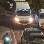 Police descend on Manchester street with man seriously hurt and woman arrested