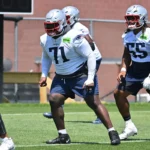 Patriots’ Linchpin: Mike Onwenu’s Status Clouded Amid Critical Injury Update