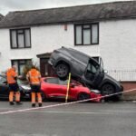 Upside-Down Commute: SUV Lands Atop Sedan in Freak City Intersection Crash