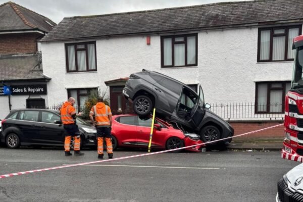 Upside-Down Commute: SUV Lands Atop Sedan in Freak City Intersection Crash